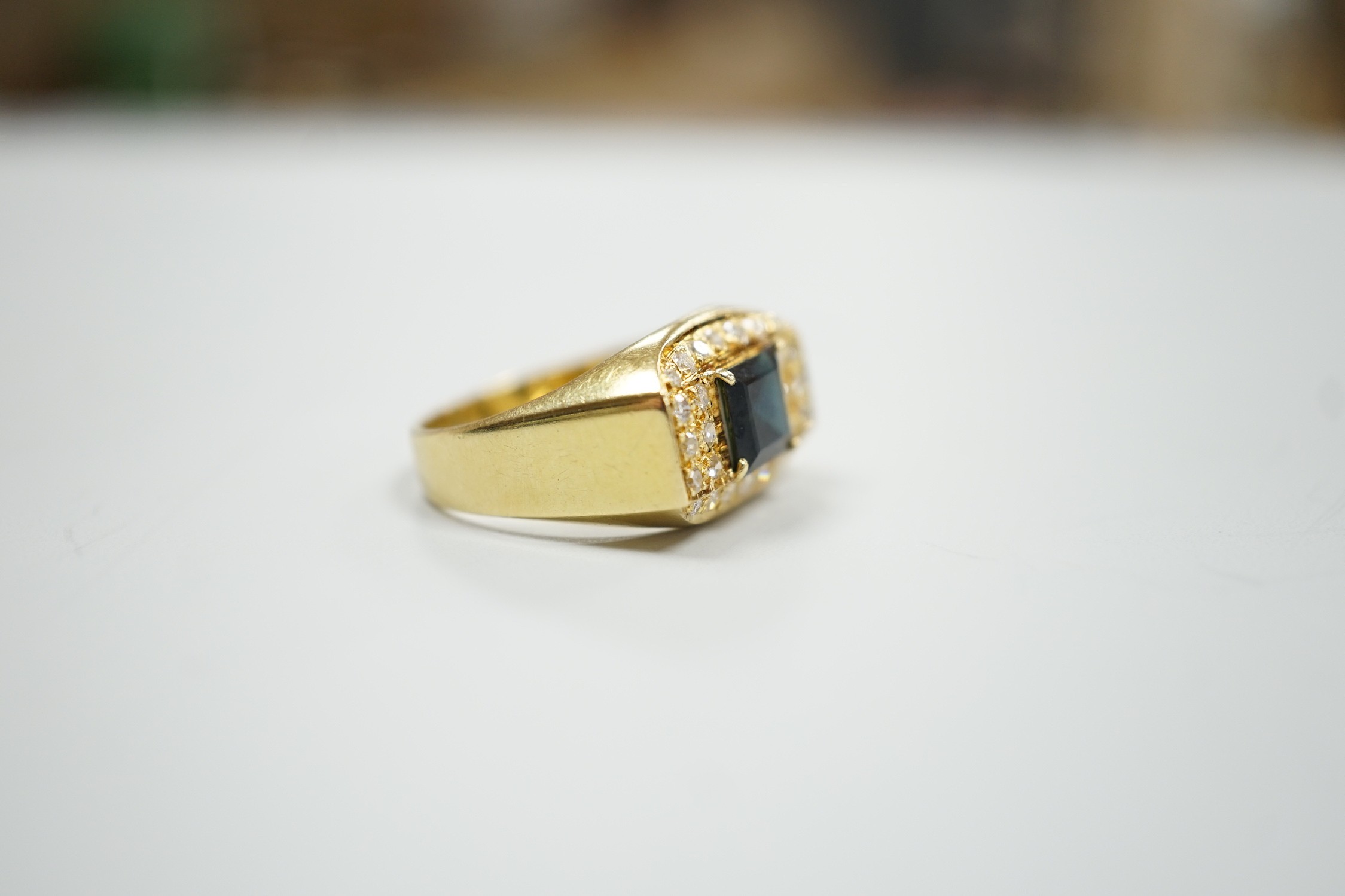 A modern 750 yellow metal, single stone sapphire and pave set diamond dress ring, size O, gross weight 5.9 grams.